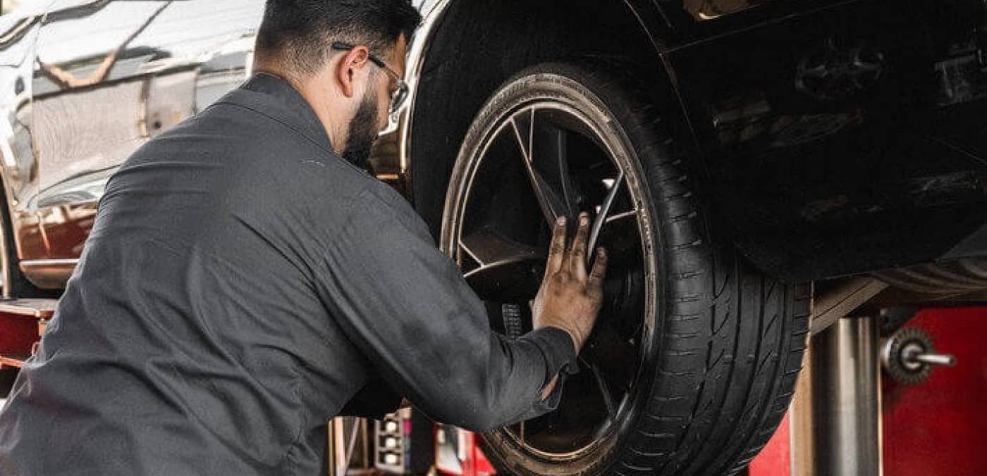 Tire Engineer Removing a Tire Image